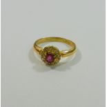An early 20th century 18 carat gold ruby and diamond circular cluster ring,