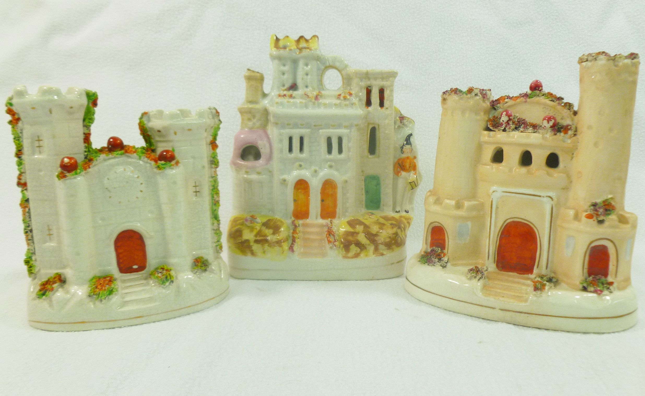 Three Staffordshire pottery flatback pastille burners in the form of castles, 18.5cm, 17cm and 14.