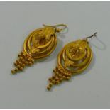 A pair of Victorian gold plated oval pendant earrings with acanthus leaf buckle and beaded fringe,