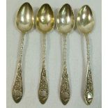 A set of four Russian silver teaspoons, the twisted handles cast with shield and scroll decoration,