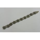 A 19th century cut steel bracelet, with ten flower head panels,