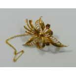 A 9 carat gold garnet set foliate bow brooch, London 1966,