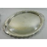 A large George V oval silver tray with wavy edge decoration and two pierced handles,