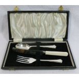 A three piece christening set with silver spoon and fork and steel bladed knife with faux ivory