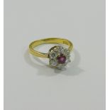 An 18 carat gold ruby and diamond daisy head cluster ring, London 1978,