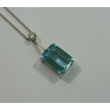 An aquamarine and diamond pendant necklace, the emerald cut aquamarine approximately 16.