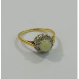 An 18 carat gold and platinum opal and diamond circular cluster ring,