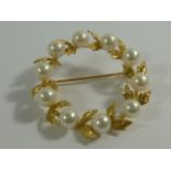 A yellow metal and cultured pearl circular wreath brooch by Mikimoto, stamped '14K', 3.