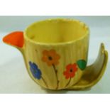 A 1930's Art Deco pottery shaving mug with bold floral and foliate decoration and orange handle,