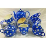 A 1950's Belgian pottery part teaset decorated with a blue ground and white polka dots comprised of