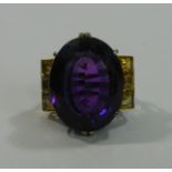 A large amethyst and citrine dress ring, the oval mixed cut amethyst approximately 52.8 carats, 28.