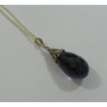 A large pear-shaped faceted amethyst pendant with diamond mount,