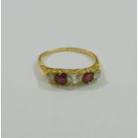 An Edwardian 18 carat gold diamond and ruby five stone carved half hoop ring, Birmingham 1903,