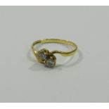 A 9 carat gold diamond two-stone cross over ring, each stone approximately 0.