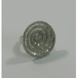 A large modern 18 carat white gold diamond spiral dress ring, the round brilliant,