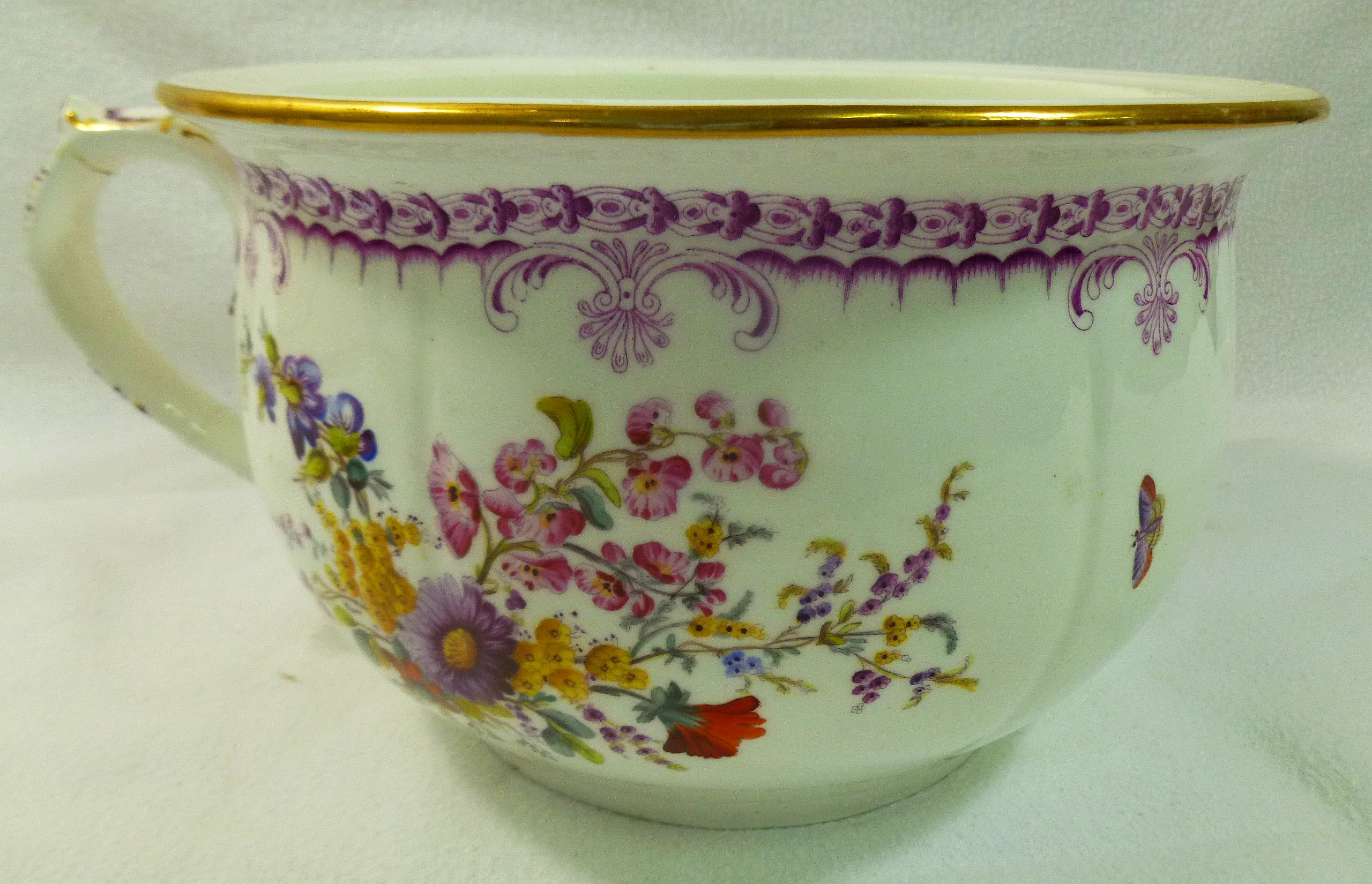 A 19th century porcelain chamber pot with printed and painted decoration of floral sprays and - Image 2 of 9