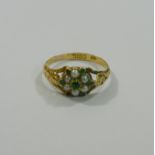 A Victorian 18 carat gold half seed pearl and emerald daisy head cluster ring,