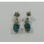 A pair of aquamarine and diamond drop earrings, the emerald cut aquamarines approximately 3.