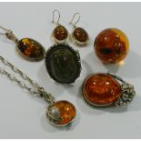 A collection of modern amber jewellery in silver coloured metal mounts,