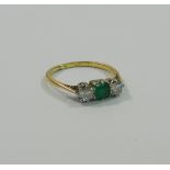 An 18 carat gold and platinum emerald and diamond three stone ring,