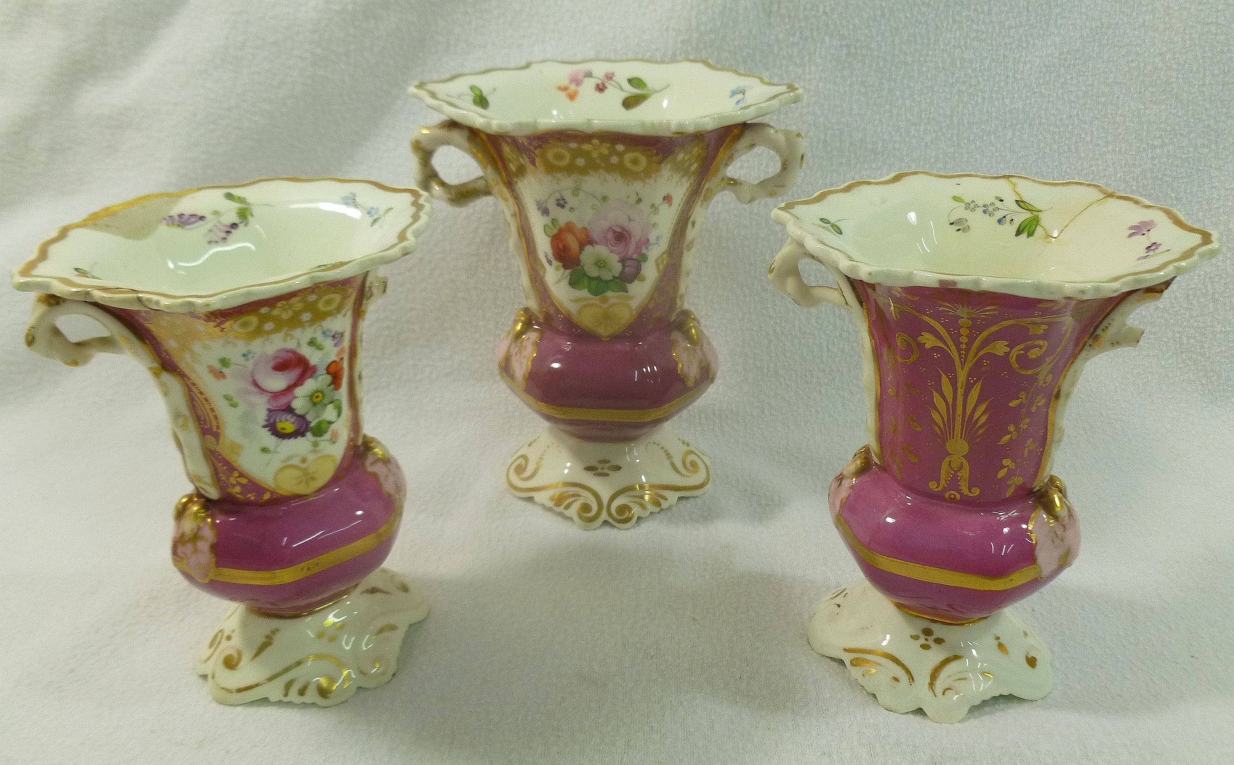 A garniture of three 19th century porcelain vases, pattern number 646, with puce ground,