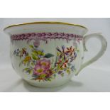 A 19th century porcelain chamber pot with printed and painted decoration of floral sprays and