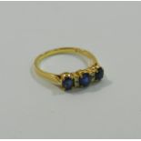 A modern yellow metal sapphire and diamond ring,