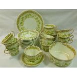 A Victorian bone china part tea service with green transfer decoration,