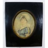 An early 19th century oval portrait miniature on ivory of a young woman, wearing a blue dress, 8.