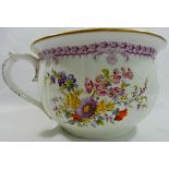 A 19th century porcelain chamber pot with printed and painted decoration of floral sprays and