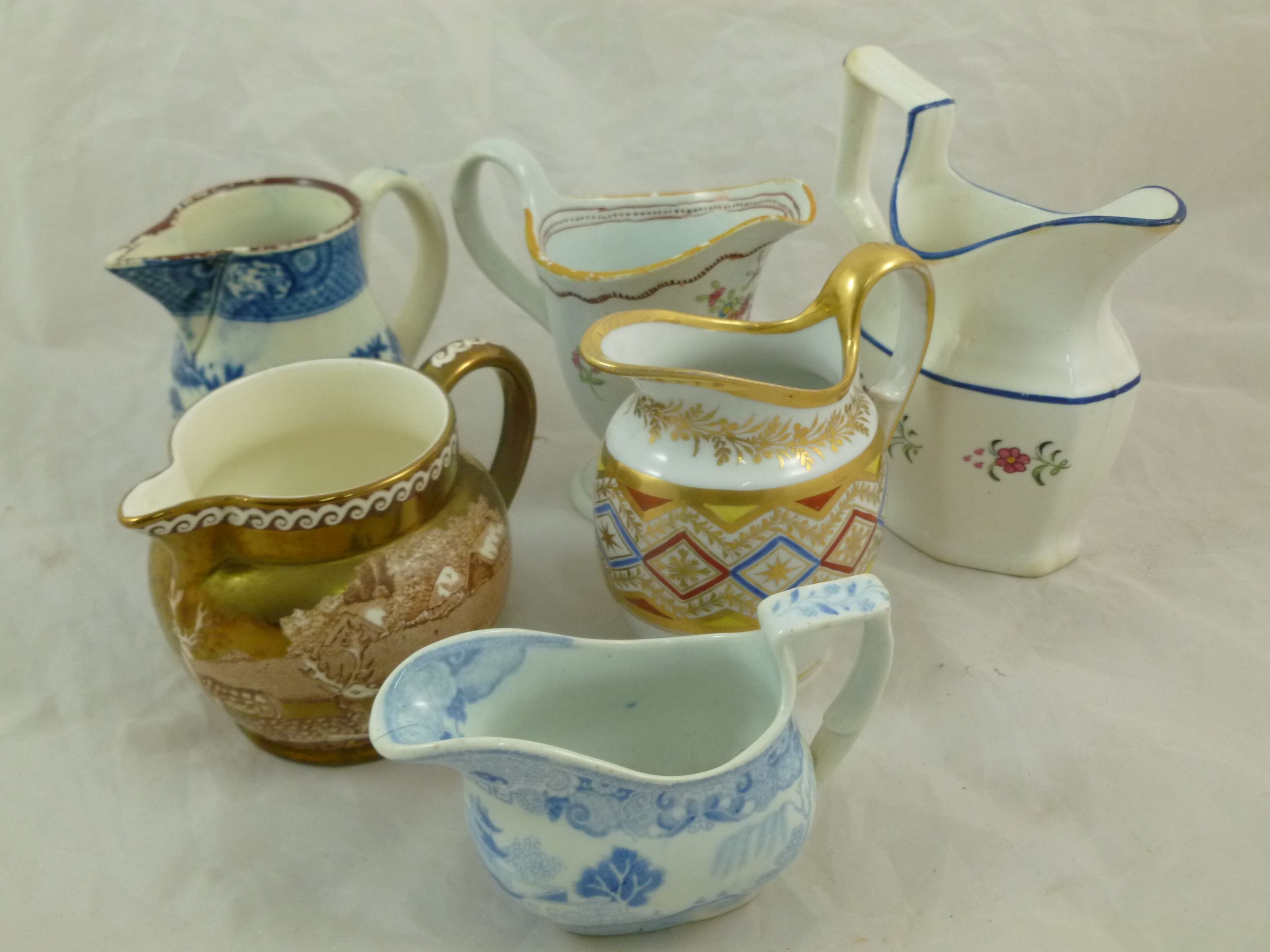 A collection of six 18th century and 19th century ceramic cream jugs including a Newhall style