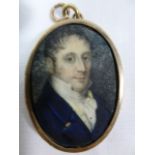 A small 19th century oval portrait miniature on ivory of a man, 3.8cm x 2.