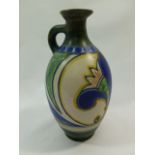 A Gouda 'Damascus' pattern pottery ewer, initialled HH to base, 18.