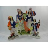 A large Staffordshire group of a man playing the accordion and a woman playing a harp, 38cm high,