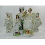 A pair of Staffordshire pottery flatback figures of a Scottish couple each with a drum,