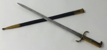 A replica German walking out bayonet with brass mounts and leather scabbard length 60cm