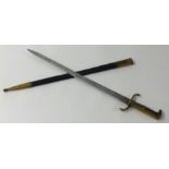 A replica German walking out bayonet with brass mounts and leather scabbard length 60cm