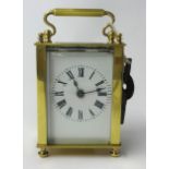 Brass case carriage clock with platform escapement and key, 11cm.