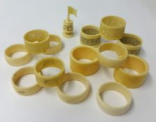 Six old ivory napkin rings, six others and one carved chest piece.