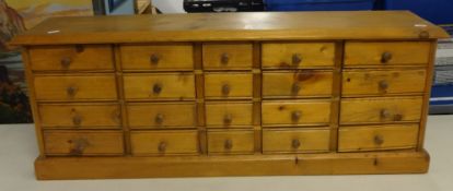 A pine bank of 20 drawers.