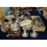 A large collection of silver plated wares including biscuit barrel, candle sticks, spill vases,