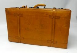 Two large leather tan suitcases.