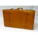 Two large leather tan suitcases.