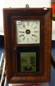 A Waterbury Clock Co, with 'OG' mahogany case, having two weights, 66cm x 39cm.