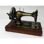 Singer sewing machine in mahogany cabinet.