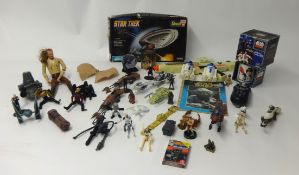 A collection of various Star Trek and Star Wars figures and memorabilia