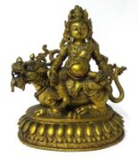 A Tibetan bronze Buddha sat on a lotus plinth, his jewellery and headdress with inset stones, height