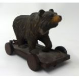 A carved wood Black Forest Bear pull along toy, height 15cm.