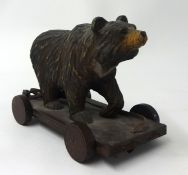 A carved wood Black Forest Bear pull along toy, height 15cm.