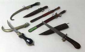 Collection of six daggers including Middle Eastern curved blade and white metal daggers also Far